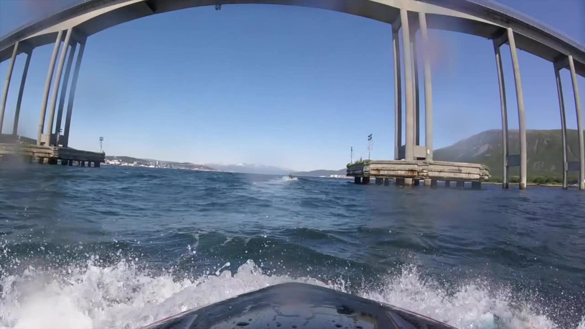 Her kjører de vannscooter under Tromsøbrua